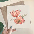 Load image into Gallery viewer, Querin Creations square greeting card with two pink poppy flowers held by a hand against a beige background and craft envelope