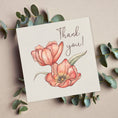Load image into Gallery viewer, Greeting card with pink flowers and 'Thank you!' text, surrounded by eucalyptus leaves on a beige background