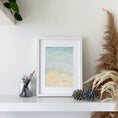 Load image into Gallery viewer, Querin Creations Watercolour seaside artwork on a shelf with decorative items and plants.
