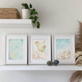 Load image into Gallery viewer, Querin Creations Three framed A4 artworks on a shelf with decorative items, coastal home decor
