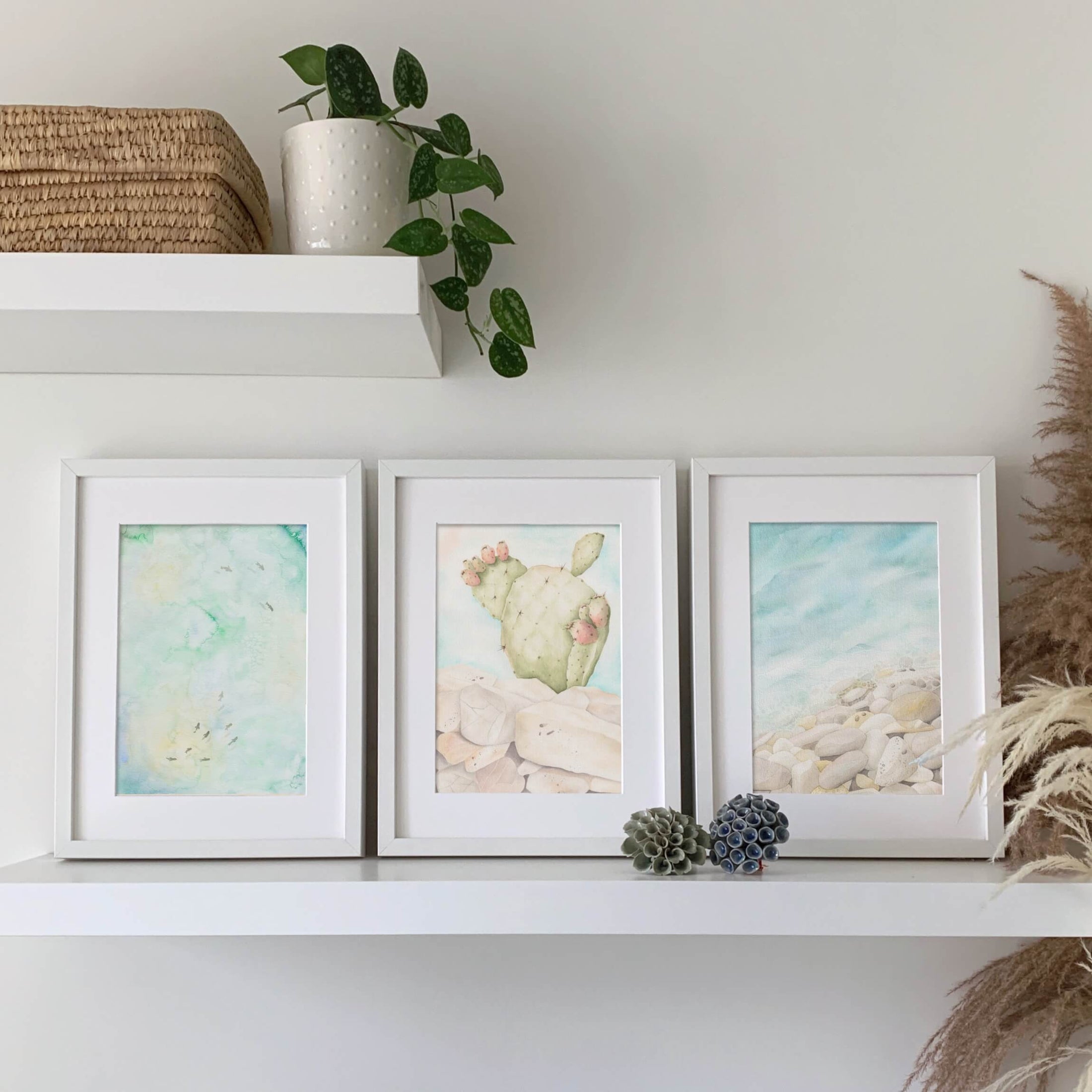 Querin Creations Three framed A4 artworks on a shelf with decorative items, coastal home decor