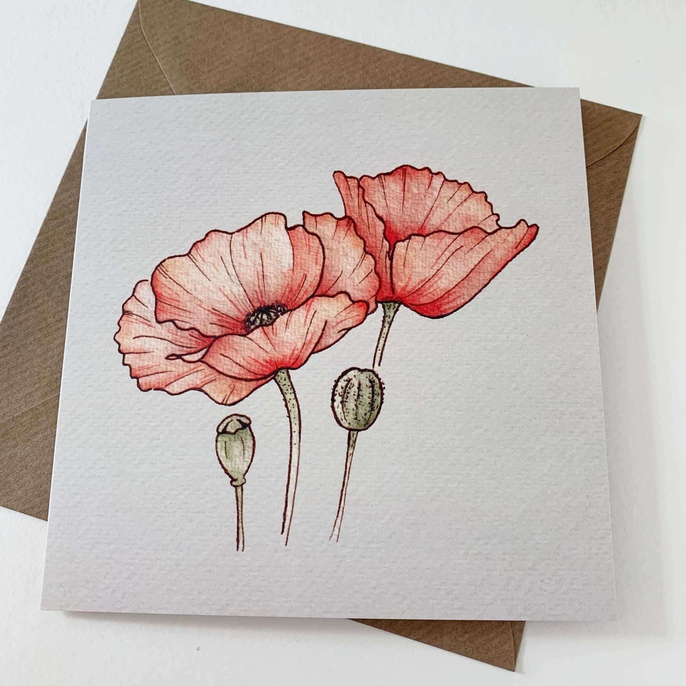Querin Creations greeting card with red poppy flowers and brown craft envelope on white background