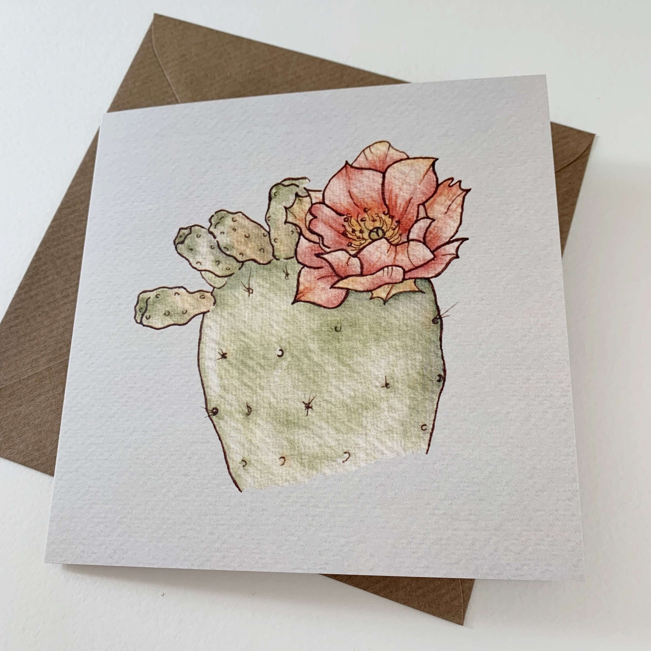 Querin Creations square greeting card with a cactus watercolour illustration featuring a pink flower and a craft envelop 