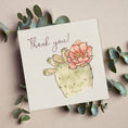 Load image into Gallery viewer, Querin Creations square greeting card with a cactus and flower illustration and 'Thank you!' text, surrounded by eucalyptus leaves.
