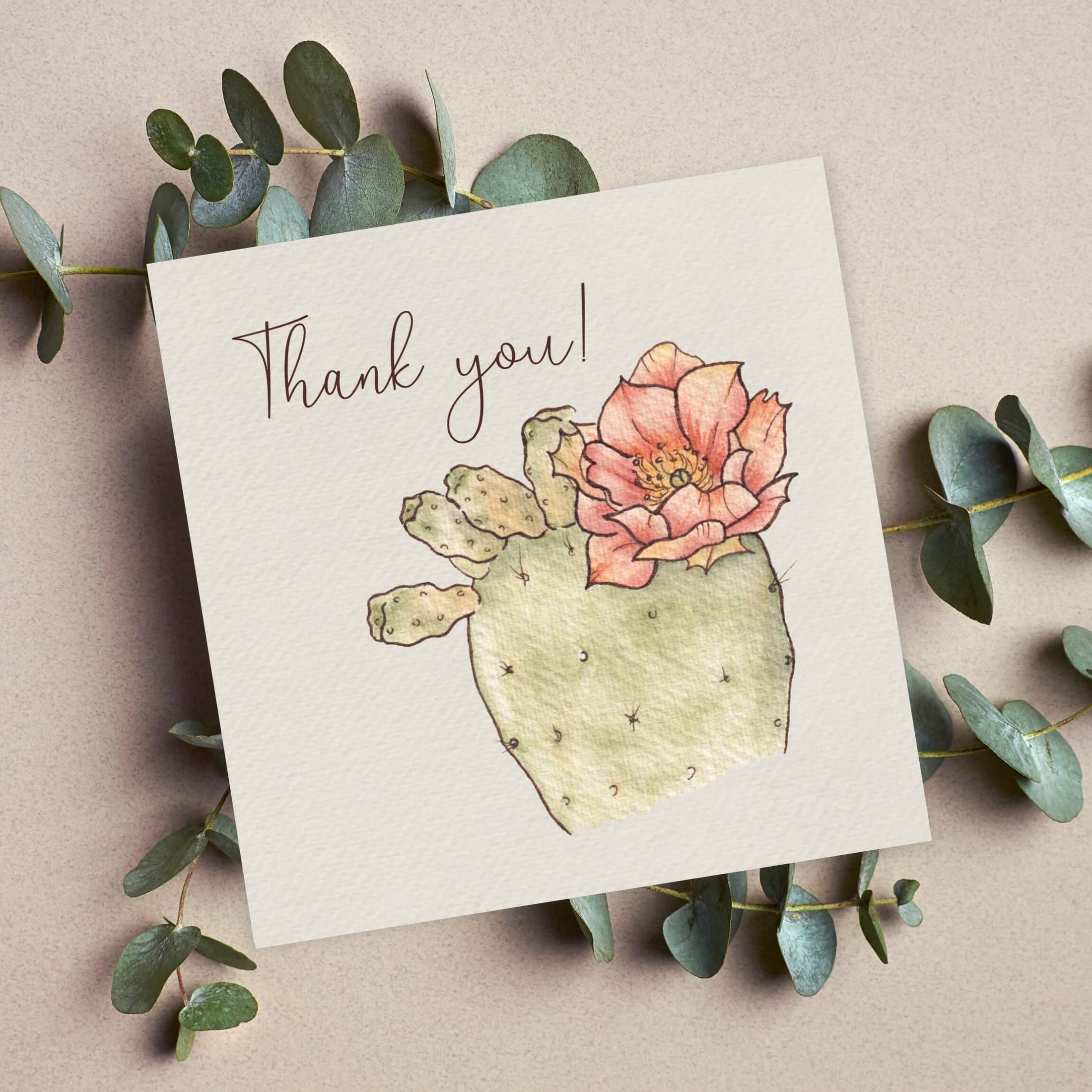 Querin Creations square greeting card with a cactus and flower illustration and 'Thank you!' text, surrounded by eucalyptus leaves.