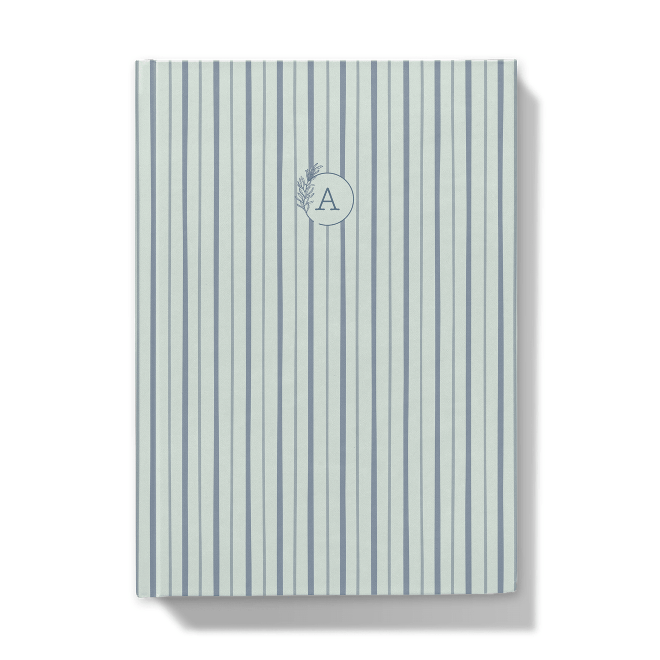 Notebook with blue striped pattern cover and floral monogram on a white background