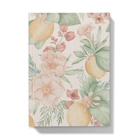 Front of notebook with lemons and mediterranean flowers pattern on a blush pick background
