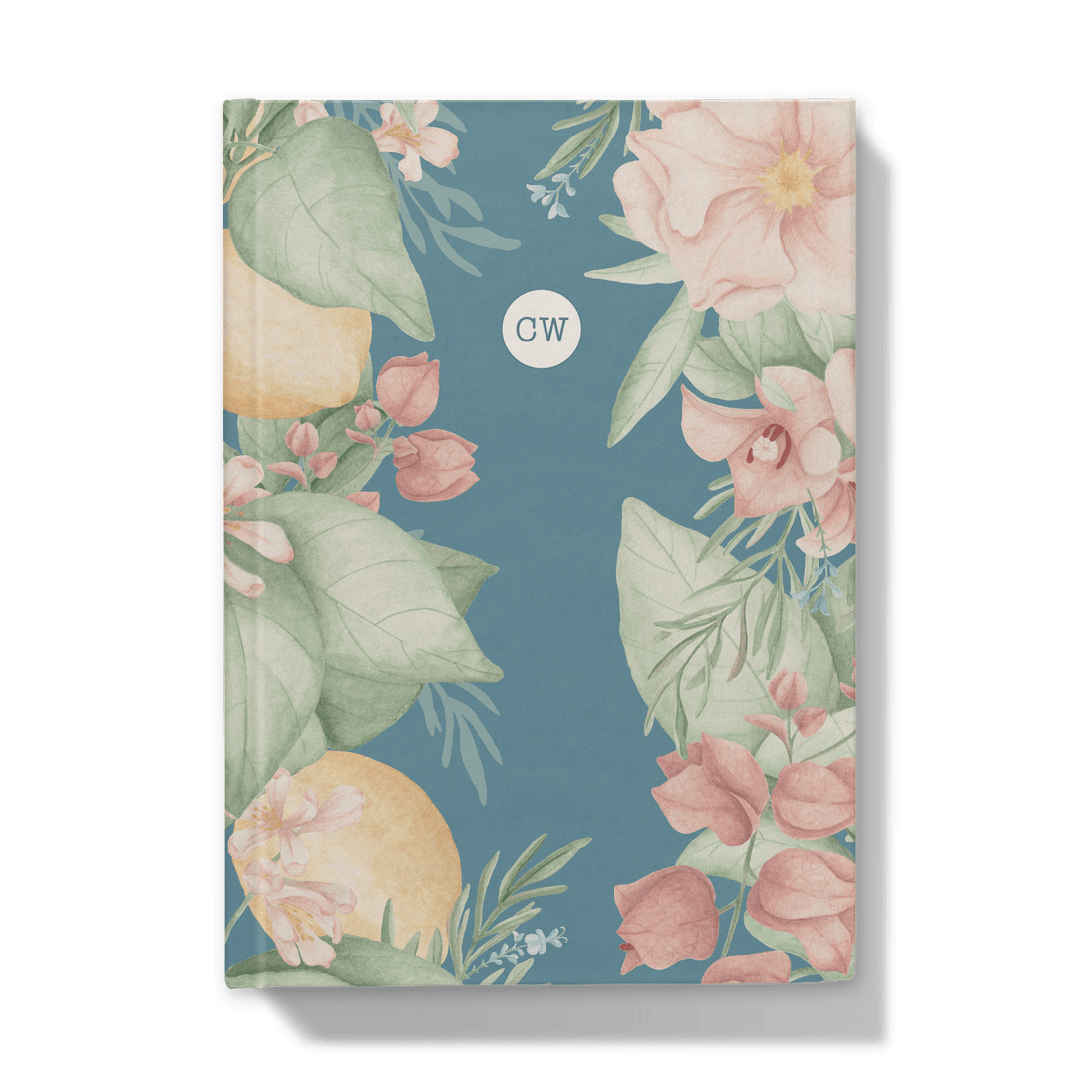Front of notebook with floral and citrus design on a blue background and circular monogram 