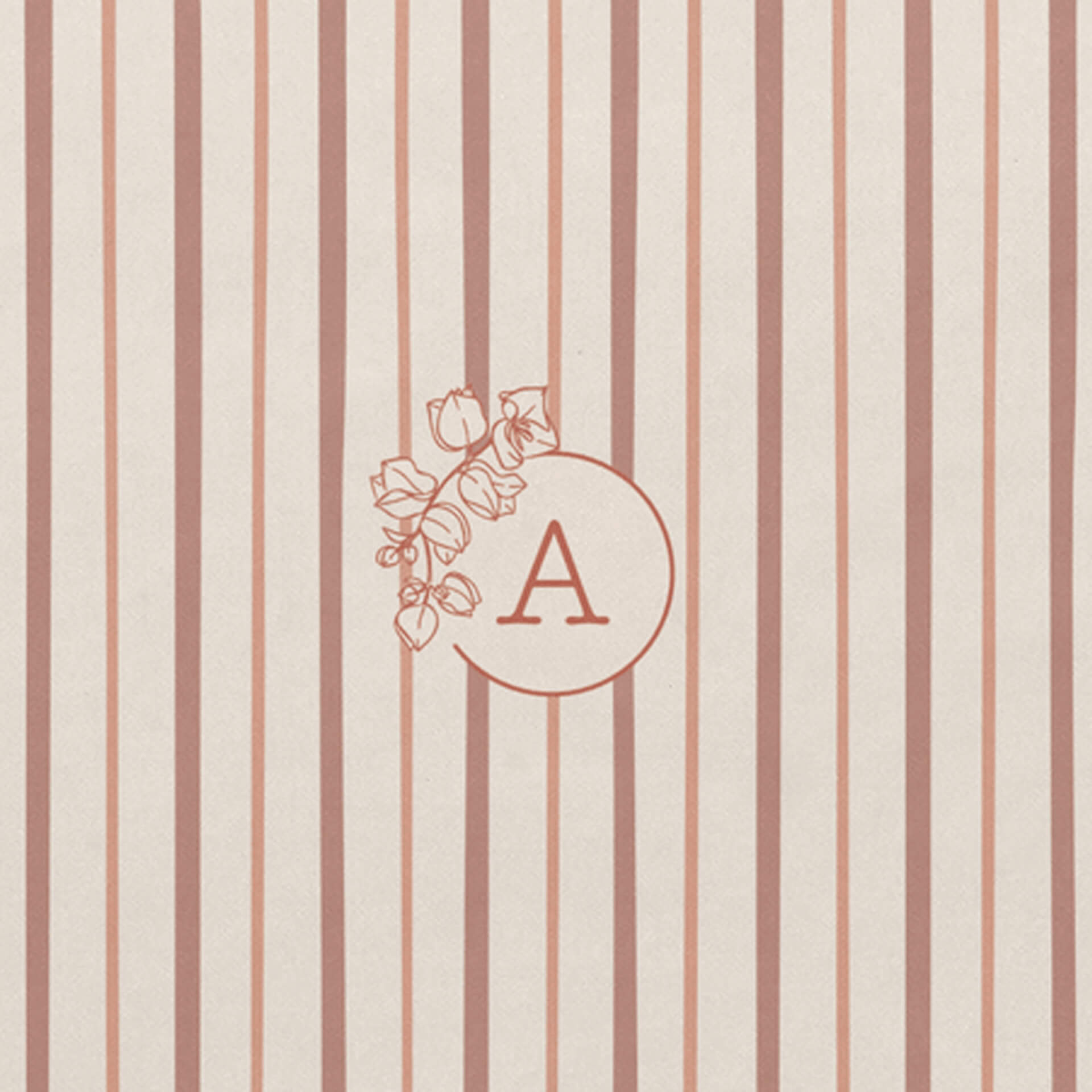 Detail of personalised floral monogram with bougainvillaea wreath on notebook with red and pink shades striped cover 
