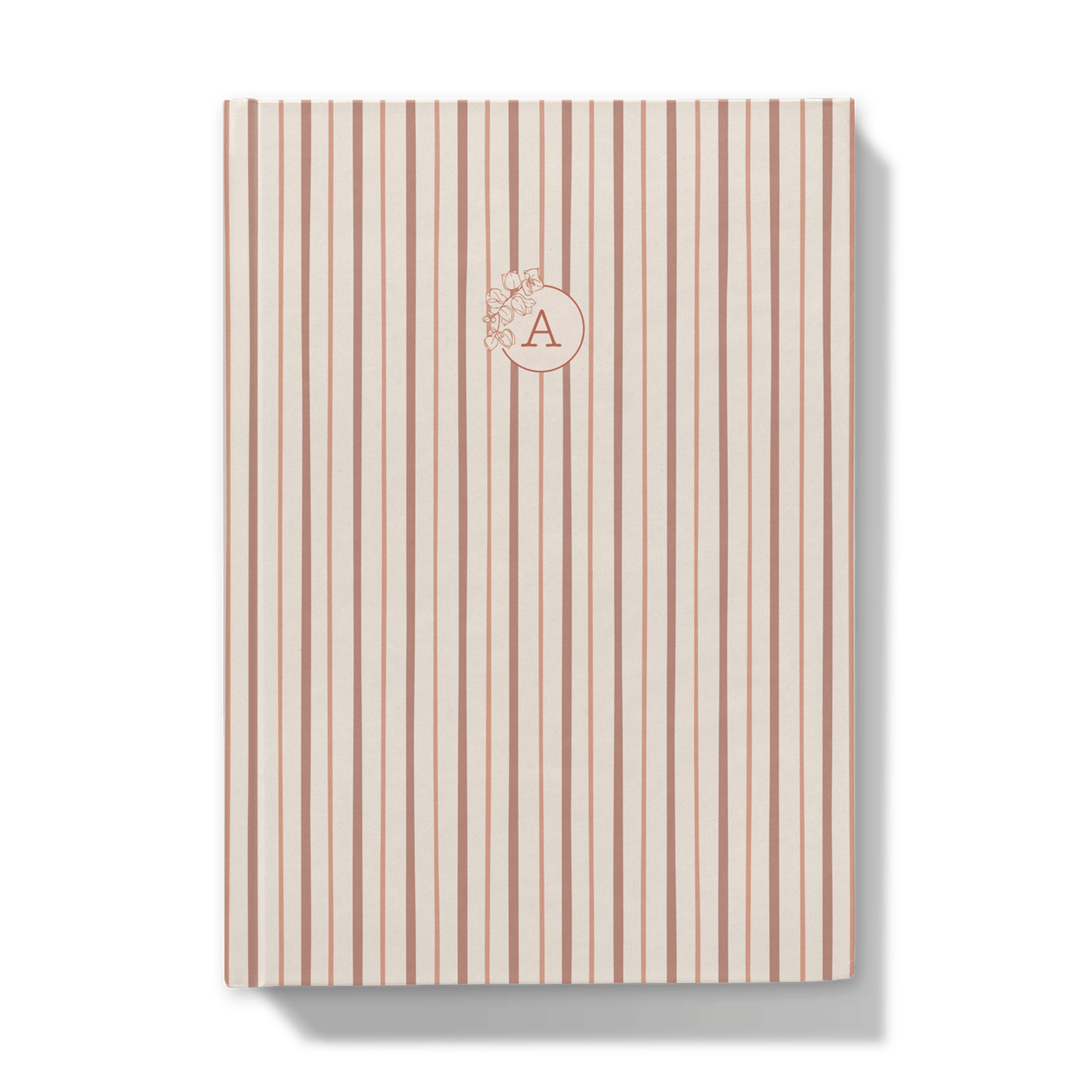 Notebook with red striped cover and floral monogram on a dust pick background