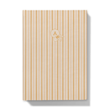 Front cover Notebook with yellow vertical stripes and a monogram on a white background
